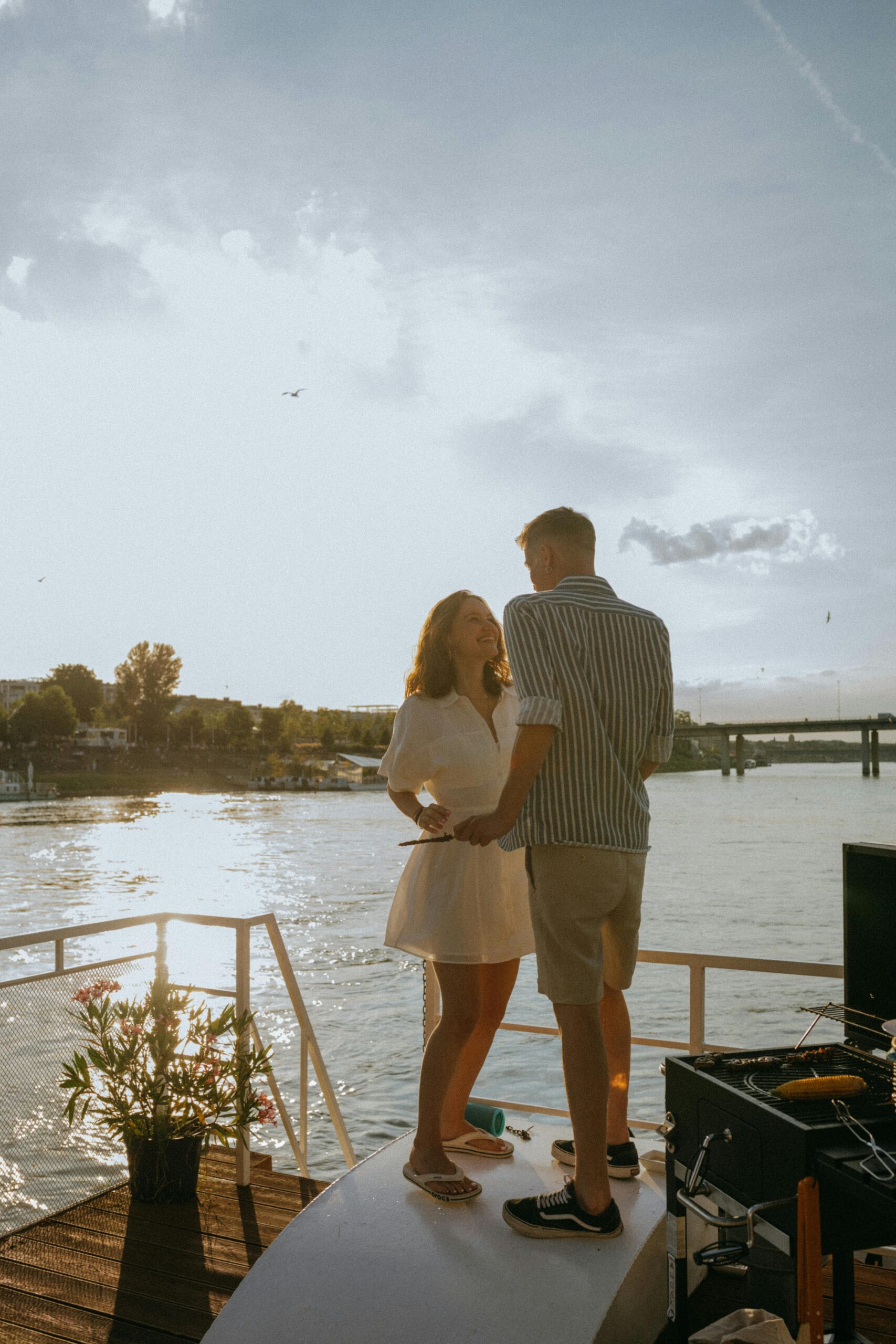 couples therapy - a couple enjoying each other's company on a dock overlooking a body of water.