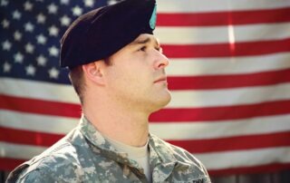 Veteran in front of American flag